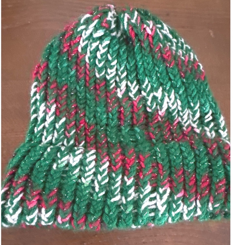 Hand-knitted festive winter beanie styled in a classic holiday color palette
